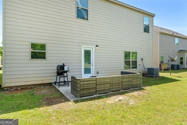 back of house with a patio area, an outdoor hangout area, a yard, and central air condition unit