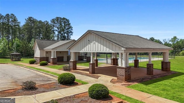 surrounding community featuring a swimming pool, a gazebo, and a yard