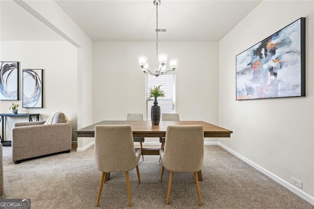 carpeted dining space with baseboards, visible vents, and a chandelier