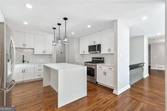 100 Little Ridge Rd, Berkeley Lake, GA 30096 - kitchen with appliances with stainless steel finishes, a center island, tasteful backsplash, light countertops, and recessed lighting