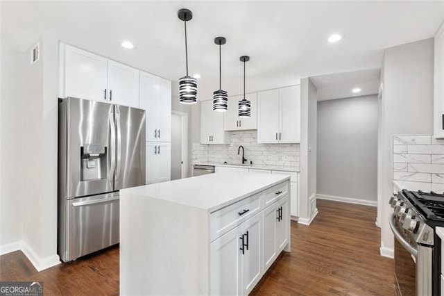 100 Little Ridge Rd, Berkeley Lake, GA 30096 - kitchen featuring appliances with stainless steel finishes, backsplash, light countertops, dark wood-style flooring, and recessed lighting