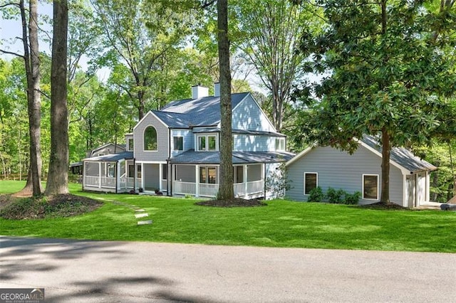 100 Little Ridge Rd, Berkeley Lake, GA 30096 - view of front of property featuring a chimney, a front yard, a garage, and a sunroom