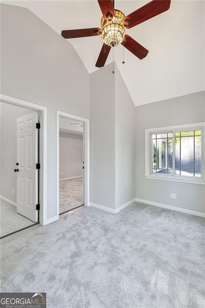 100 Little Ridge Rd, Berkeley Lake, GA 30096 - carpeted spare room with high vaulted ceiling and ceiling fan
