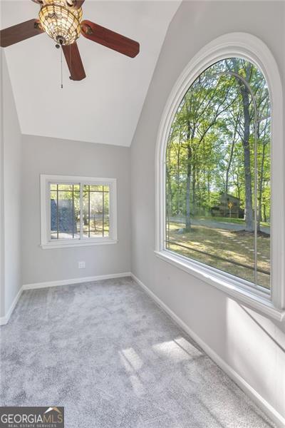 100 Little Ridge Rd, Berkeley Lake, GA 30096 - carpeted empty room with vaulted ceiling and ceiling fan