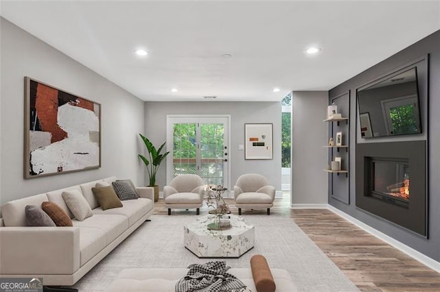 100 Little Ridge Rd, Berkeley Lake, GA 30096 - living area with wood finished floors, recessed lighting, and a glass covered fireplace