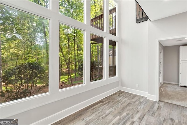 100 Little Ridge Rd, Berkeley Lake, GA 30096 - unfurnished sunroom featuring wood finished floors, healthy amount of natural light, and a towering ceiling