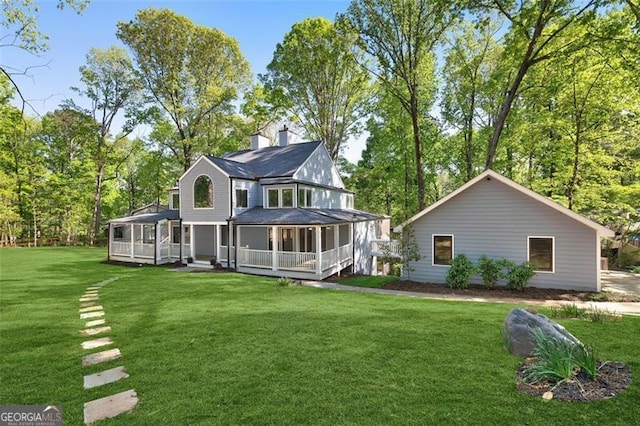 100 Little Ridge Rd, Berkeley Lake, GA 30096 - back of property with a sunroom, a yard, and a chimney