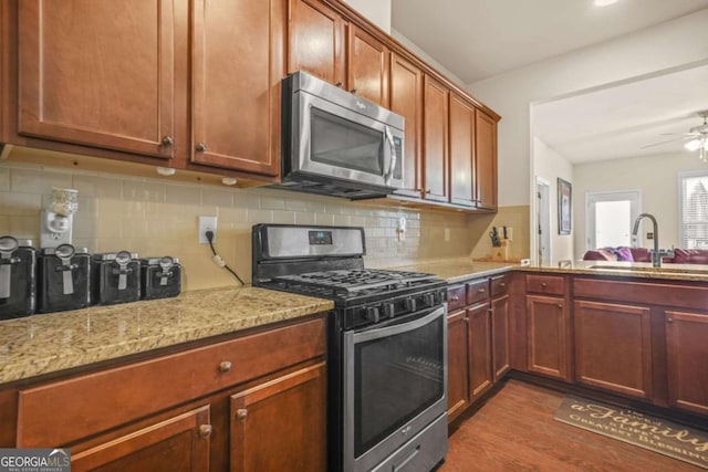 5030 Breezewood Cir, Alpharetta, GA 30004 - kitchen with tasteful backsplash, a sink, stainless steel appliances, dark wood-style flooring, and light stone countertops