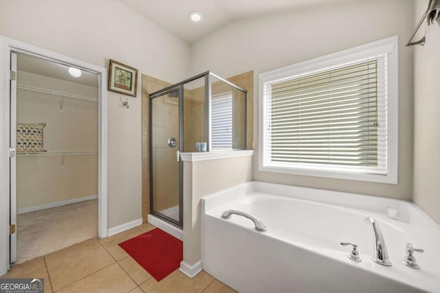 5030 Breezewood Cir, Alpharetta, GA 30004 - bathroom with a bath, a spacious closet, tile patterned floors, and a stall shower