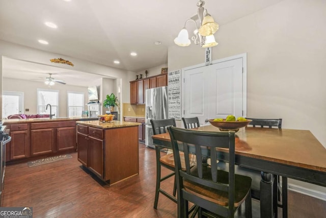 5030 Breezewood Cir, Alpharetta, GA 30004 - kitchen with recessed lighting, dark wood finished floors, a sink, a center island, and stainless steel fridge