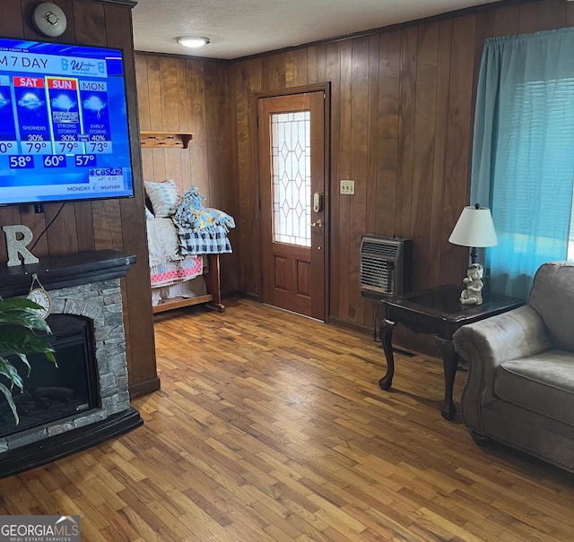 3065 County Road 69, Centre, AL 35960 - foyer entrance with heating unit, wood walls, wood finished floors, and a fireplace
