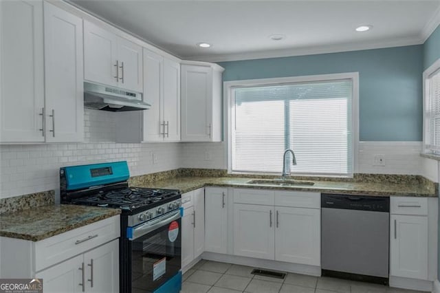 4175 Danforth, Atlanta, GA 30331 - kitchen with stainless steel appliances, under cabinet range hood, crown molding, white cabinets, and dark stone counters