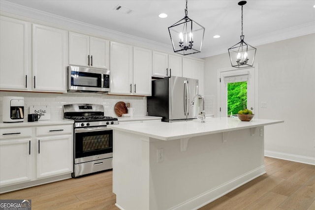 4240 Spring Rdg, Cumming, GA 30028 - kitchen featuring stainless steel appliances, a sink, light wood-style floors, light countertops, and white cabinetry