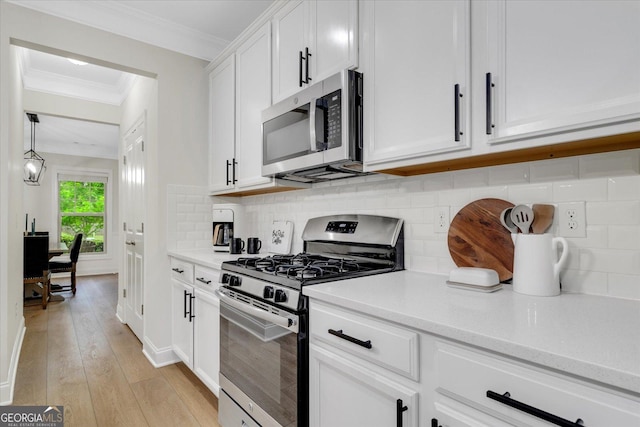 4240 Spring Rdg, Cumming, GA 30028 - kitchen featuring appliances with stainless steel finishes, white cabinets, and tasteful backsplash