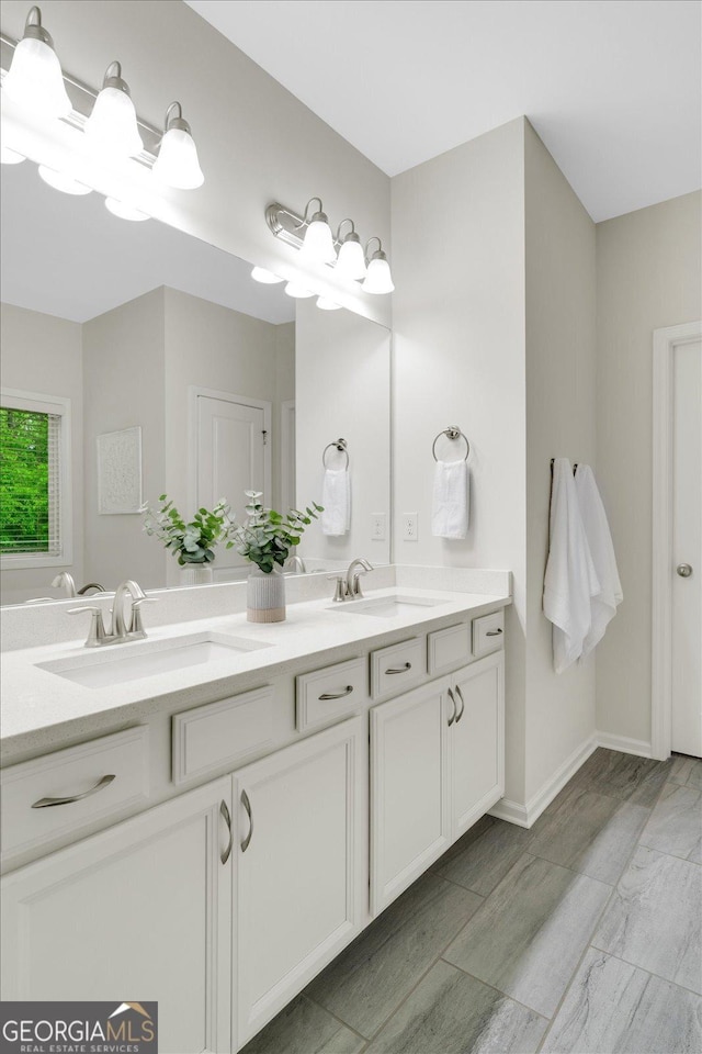 4240 Spring Rdg, Cumming, GA 30028 - bathroom featuring double vanity, a bath, and baseboards