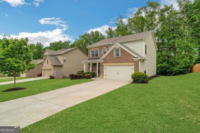 4240 Spring Rdg, Cumming, GA 30028 - view of front of house featuring driveway, brick siding, a front lawn, and a garage