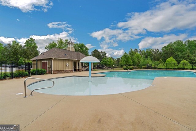 4240 Spring Rdg, Cumming, GA 30028 - community pool featuring a patio area and view of wooded area