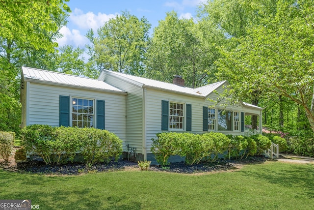 1531 E Broad St, Greensboro, GA 30642 - view of property exterior with a lawn, a chimney, crawl space, and metal roof