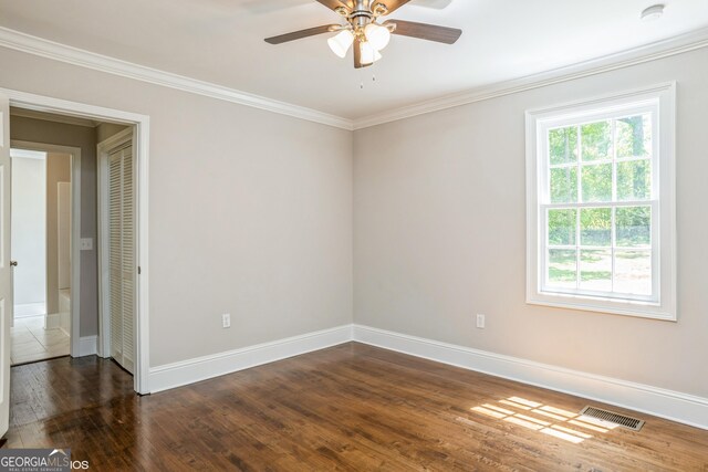 1531 E Broad St, Greensboro, GA 30642 - unfurnished room featuring dark wood-type flooring, visible vents, ceiling fan, and a healthy amount of sunlight
