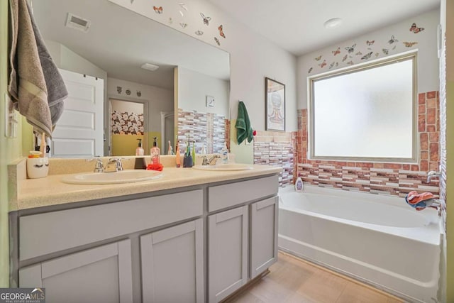 11893 Lovejoy Crossing Blvd, Hampton, GA 30228 - bathroom featuring double vanity and a garden tub