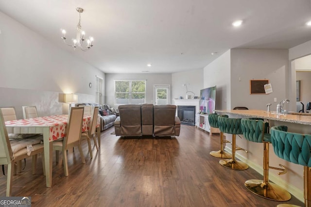 11893 Lovejoy Crossing Blvd, Hampton, GA 30228 - dining space featuring dark wood-type flooring, a chandelier, recessed lighting, and a glass covered fireplace