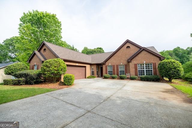 8640 Amberfield Dr, Gainesville, GA 30506 - ranch-style house featuring a garage, concrete driveway, roof with shingles, and brick siding