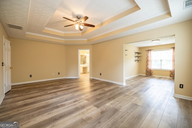8640 Amberfield Dr, Gainesville, GA 30506 - unfurnished room with a raised ceiling, ceiling fan, wood finished floors, and visible vents