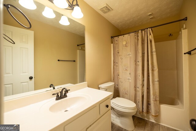 8640 Amberfield Dr, Gainesville, GA 30506 - full bath with vanity, toilet, wood finished floors, shower / tub combo, and visible vents