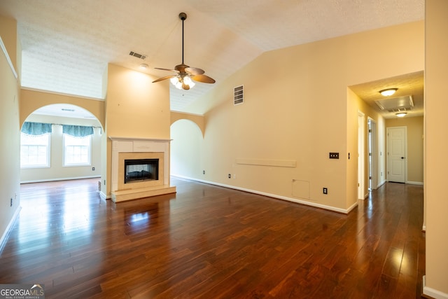 8640 Amberfield Dr, Gainesville, GA 30506 - unfurnished living room with a ceiling fan, dark wood-style flooring, visible vents, baseboards, and a glass covered fireplace