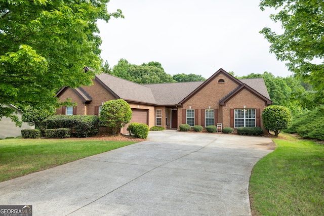 8640 Amberfield Dr, Gainesville, GA 30506 - ranch-style home featuring a garage, a front yard, roof with shingles, brick siding, and driveway