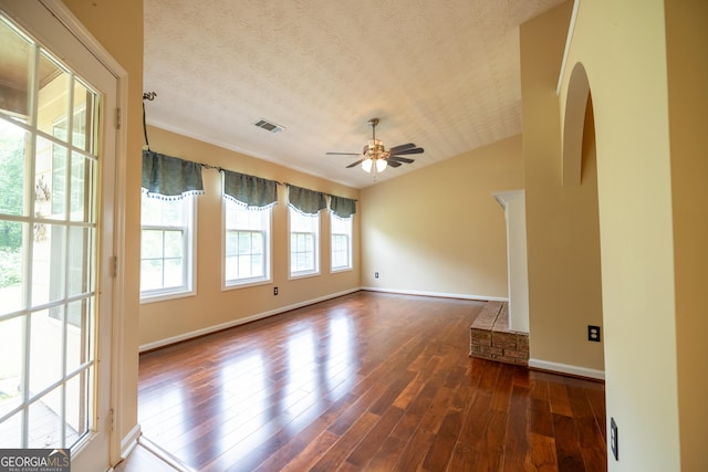 8640 Amberfield Dr, Gainesville, GA 30506 - empty room featuring ceiling fan, arched walkways, baseboards, visible vents, and dark wood-style floors