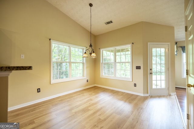 8640 Amberfield Dr, Gainesville, GA 30506 - unfurnished dining area with a textured ceiling, visible vents, light wood-type flooring, baseboards, and a chandelier