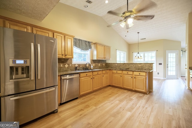 8640 Amberfield Dr, Gainesville, GA 30506 - kitchen featuring a sink, appliances with stainless steel finishes, light wood-style floors, and a peninsula