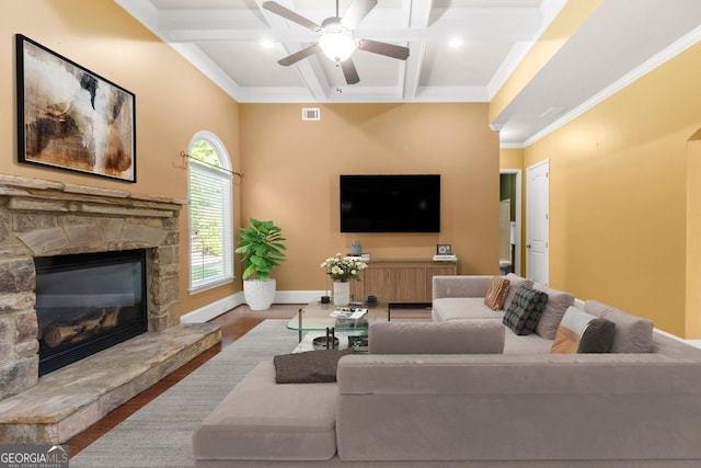 living area with baseboards, coffered ceiling, beam ceiling, and a fireplace