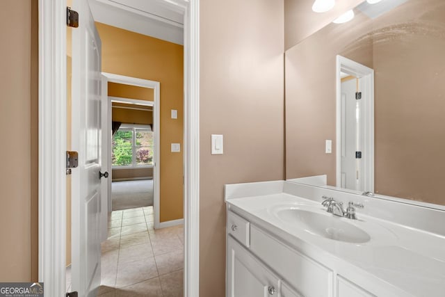 bathroom featuring baseboards, vanity, and tile patterned flooring