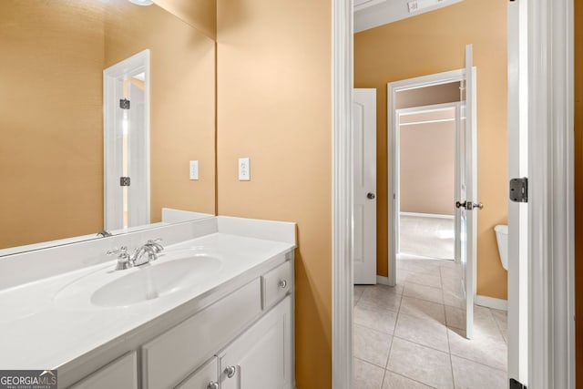 bathroom featuring baseboards, tile patterned flooring, and vanity