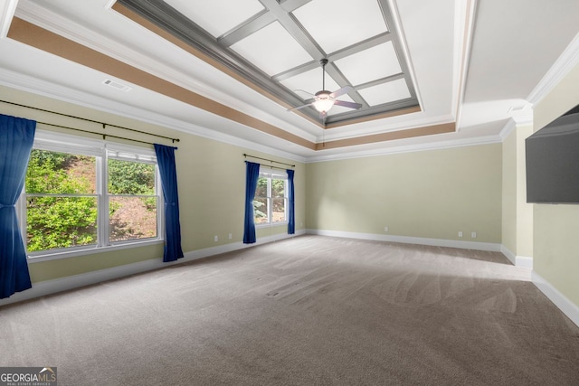 carpeted empty room with crown molding, ceiling fan, a tray ceiling, baseboards, and visible vents