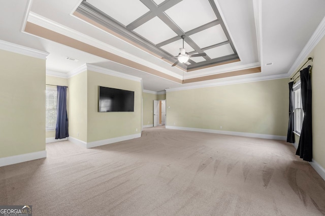 unfurnished living room with a ceiling fan, ornamental molding, a raised ceiling, and light colored carpet