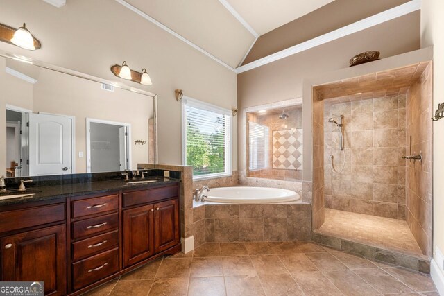 bathroom featuring a tile shower, vaulted ceiling, double vanity, ornamental molding, and a bath