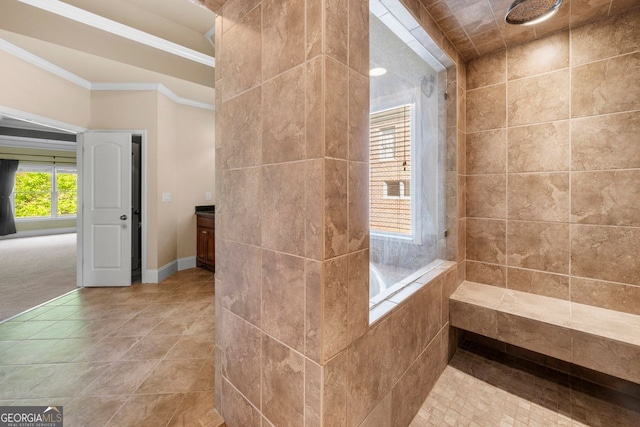 bathroom featuring tiled shower, vanity, tile patterned floors, and crown molding