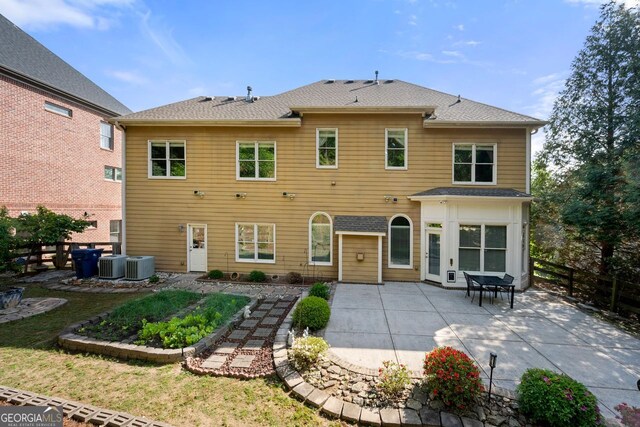 back of house featuring central air condition unit, a patio area, and fence