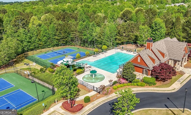 birds eye view of property featuring a view of trees