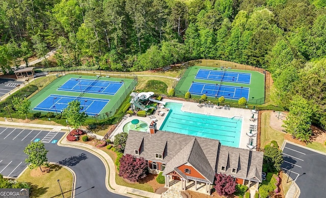 bird's eye view with a wooded view