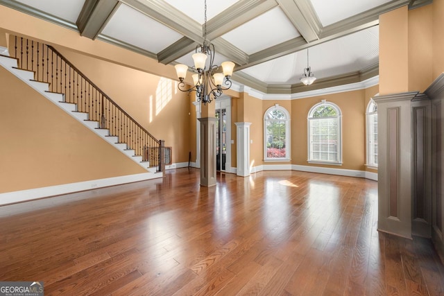 unfurnished living room with stairway, coffered ceiling, beam ceiling, baseboards, and a chandelier