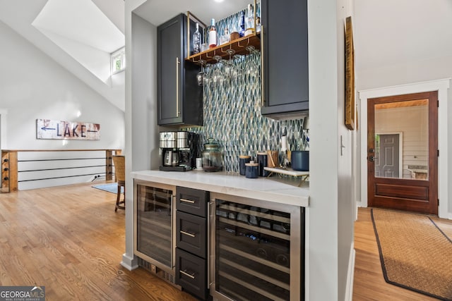 5527 Little River Cir, Gainesville, GA 30506 - indoor dry bar with wine cooler, wood finished floors, backsplash, and high vaulted ceiling