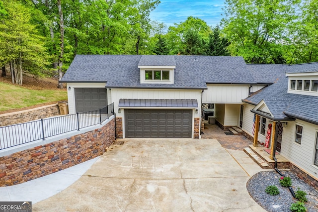 5527 Little River Cir, Gainesville, GA 30506 - view of front facade featuring a shingled roof, an attached garage, stone siding, and driveway