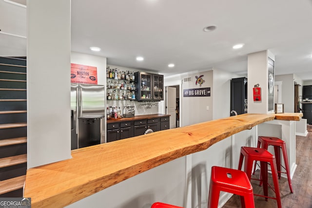 5527 Little River Cir, Gainesville, GA 30506 - indoor wet bar featuring stainless steel refrigerator with ice dispenser, wood finished floors, stairway, and recessed lighting