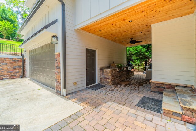5527 Little River Cir, Gainesville, GA 30506 - view of patio with exterior kitchen, a garage, driveway, and a ceiling fan
