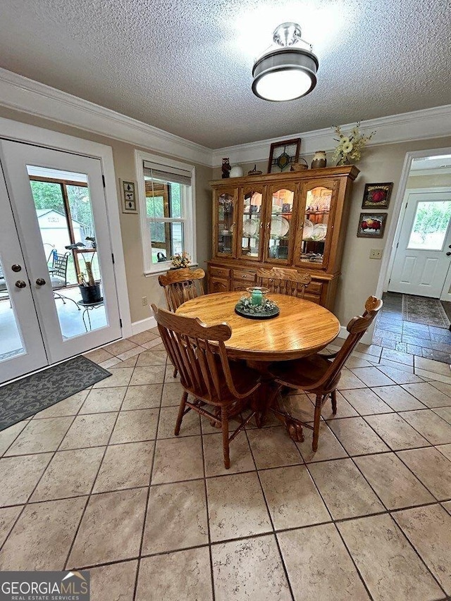 2118 Deer Run Cir, Tifton, GA 31793 - dining space featuring a textured ceiling, ornamental molding, plenty of natural light, french doors, and baseboards