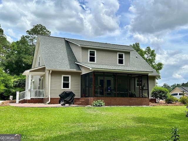 2118 Deer Run Cir, Tifton, GA 31793 - back of house featuring a sunroom, a lawn, and roof with shingles